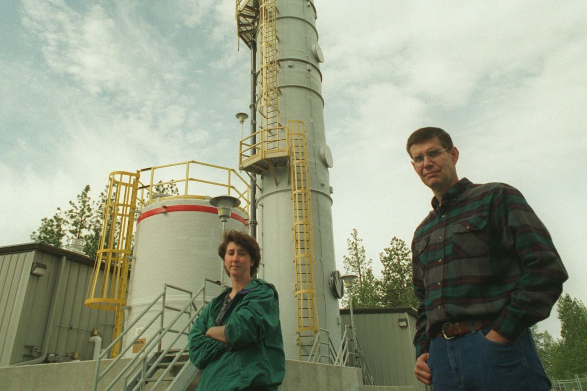 Spokane County senior environmental technicians Deb Geiger, left, and Steven Anderson in 1995 stand in front of an air stripper at the Colbert Landfill that removes contaminants from groundwater.  (COLIN MULVANY/THE SPOKESMAN-REVIEW)