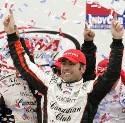
Dario Franchitti, of Scotland, celebrates his first place finish in the IRL's Iowa Corn Indy 250 auto race Sunday. Associated Press
 (Associated Press / The Spokesman-Review)