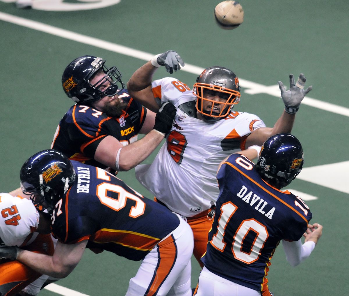 Spokane’s Katon Bethay (97) and Ryan Belcher (77) protect quarterback Nick Davila from Boise defenders.  (Dan Pelle / The Spokesman-Review)