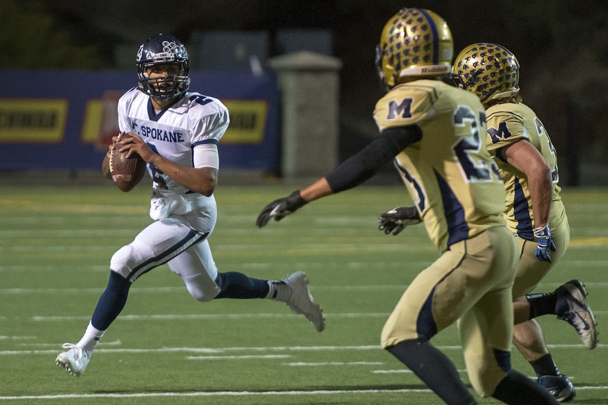 Mt. Spokane quarterback Stu Stiles, left, scored the only touchdown of the game on a 25-yard run in the first quarter. (Colin Mulvany)