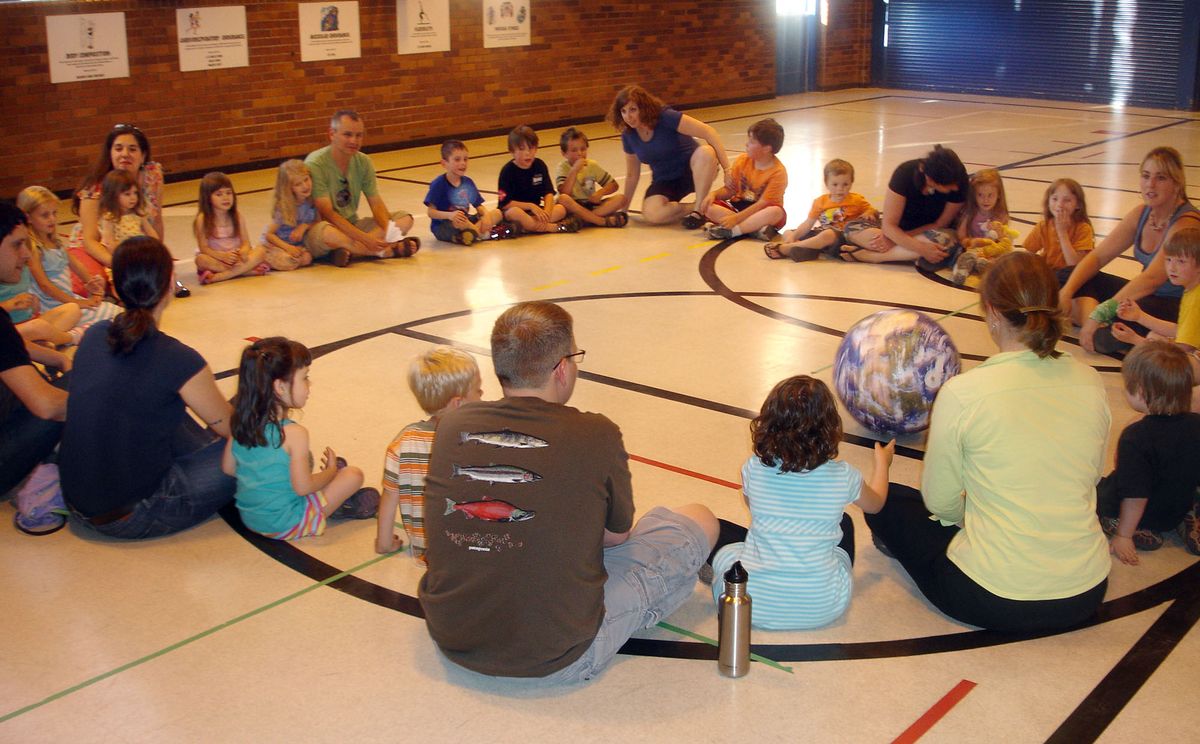 Parents and children gather in a circle at Jefferson Elementary for their first Earth Scouts meeting last month. During an icebreaker, they take turns sharing their names and ideas by rolling an inflatable Earth ball to each other. Courtesy of Russ Posten (Courtesy of Russ Posten / The Spokesman-Review)