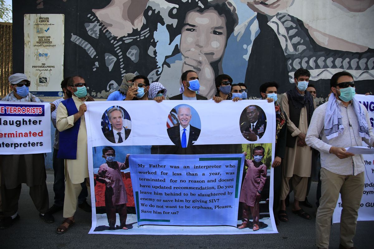 In this June 25, 2021 photo, Former Afghan interpreters hold placards during a demonstrations against the US government, in front of the US Embassy in Kabul, Afghanistan. The Biden administration says it will evacuate about 2,500 Afghans who worked for the U.S. government and their families to a military base in Virginia pending approval of their visas. The administration notified Congress on Monday that the Afghans will be housed at the Fort Lee Army base south of Richmond starting next week.  (Mariam Zuhaib)