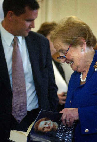 
Former Secretary of State Madeleine Albright signs her book after Wednesday's press confernece at EWU. 
 (Jed Conklin / The Spokesman-Review)