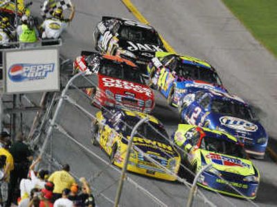 
Jamie McMurray, left, in the Irwin car, edges Kyle Busch and the rest of the field Saturday to win the NASCAR Pepsi 400 at Daytona International Speedway in Daytona Beach, Fla. 
 (Associated Press / The Spokesman-Review)