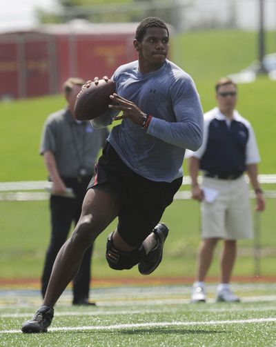 Terrelle Pryor, working out for scouts earlier this month, has yet to report to the Raiders. (Associated Press)