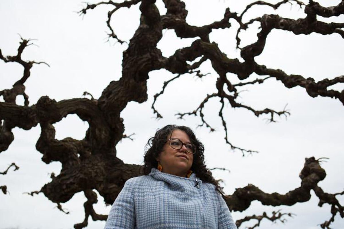 Yesenia Navarrete Hunter, a professor of history at Heritage University who did her dissertation on the story of Japanese couple Hatsue and Tokichi “Frank” Fukuda, stands for a portrait in front of a mulberry tree outside the Yakima Muddhist Church in Wapato, Wash., on Thursday, Feb. 17, 2022.  (Emree Weaver/Yakima Hearld-Republic)