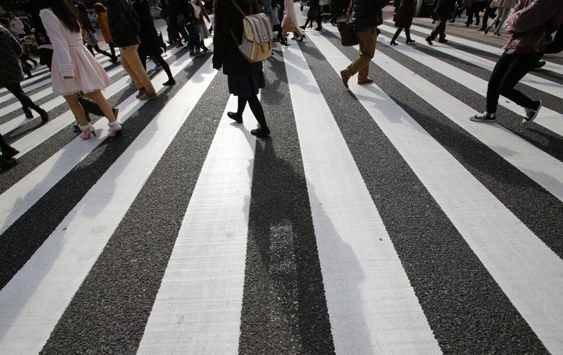 People walk on a pedestrian crossing in Tokyo on Jan. 14, 2015.  (AP Photo/Shizuo Kambayashi)