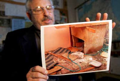 
Carl Friedman, director of San Francisco Animal Care and Control, shows a photograph of a doghouse where conditions were considered bad enough for the dog to be rescued immediately, at his office in San Francisco on Tuesday. 
 (Associated Press / The Spokesman-Review)
