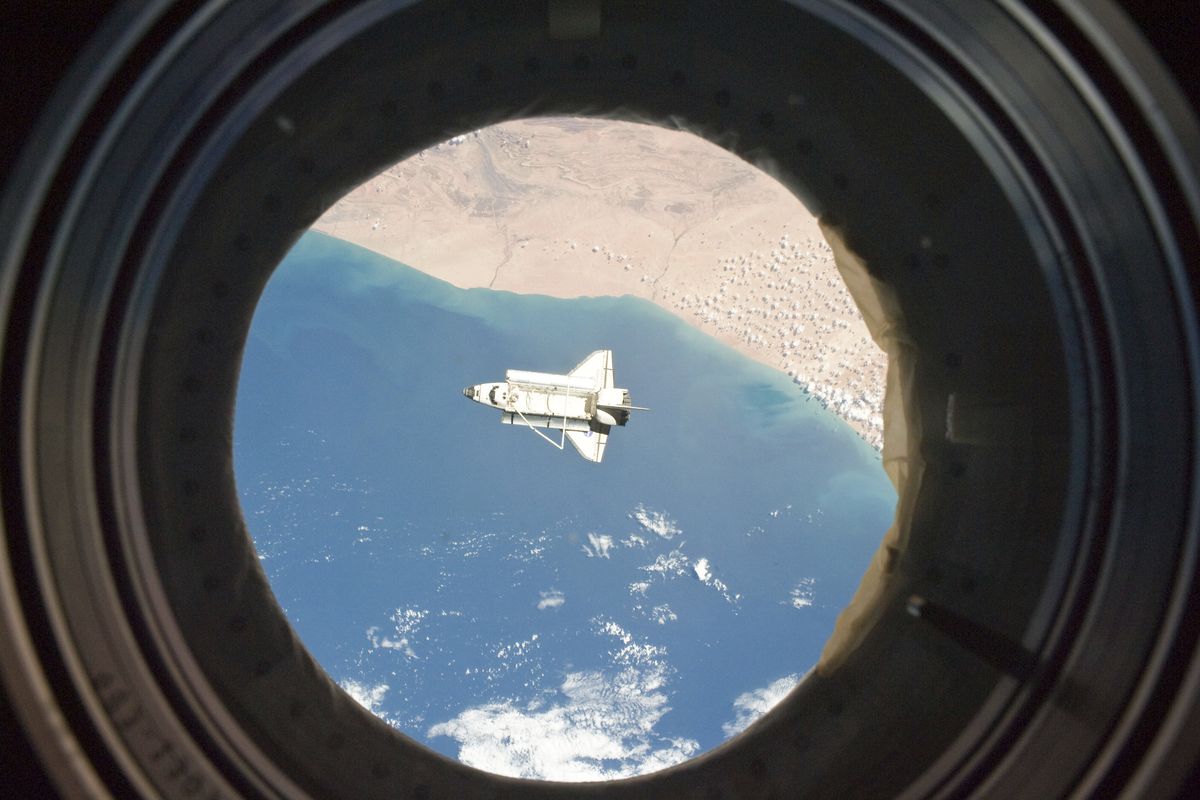 In this image provided by NASA the space shuttle Discovery is seen from the International Space Station as the two orbital spacecraft accomplish their relative separation March 7 after an aggregate of 12 astronauts and cosmonauts worked together for over a week. The area below is the southwestern coast of Morocco in the northern Atlantic. (AP/NASA)