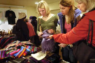 
Sisters Alana, left, and Marisa Hagney and their mom Pat Hagney, of Spokane, look at Guatemalan scarves from MoonFlower Enterprises as they shop for Christmas presents at the Festival of Fair Trade in the Community Building on Saturday morning. The festival continues today from 10 a.m. to 6 p.m. 
 (Holly Pickett / The Spokesman-Review)