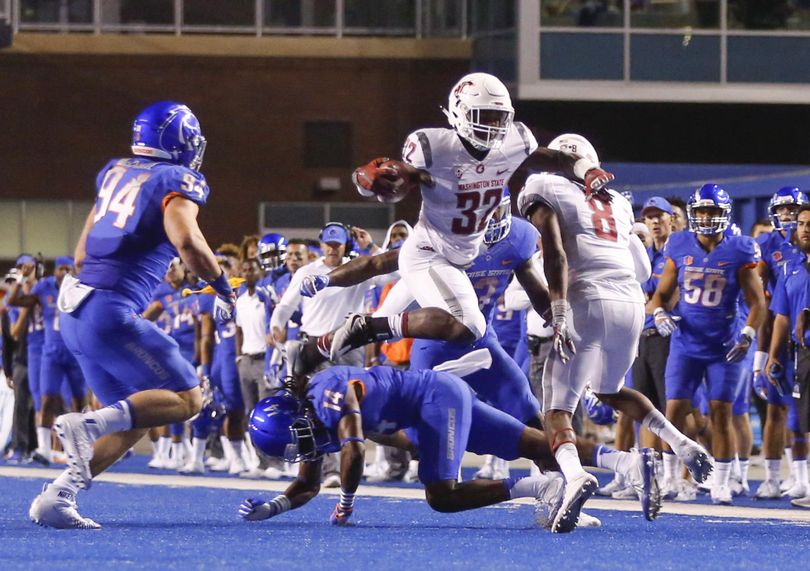 Washington State running back James Williams leaps over Boise State cornerback Tyler Horton in the first half on Saturday in Boise, Idaho. (Otto Kitsinger / Associated Press)