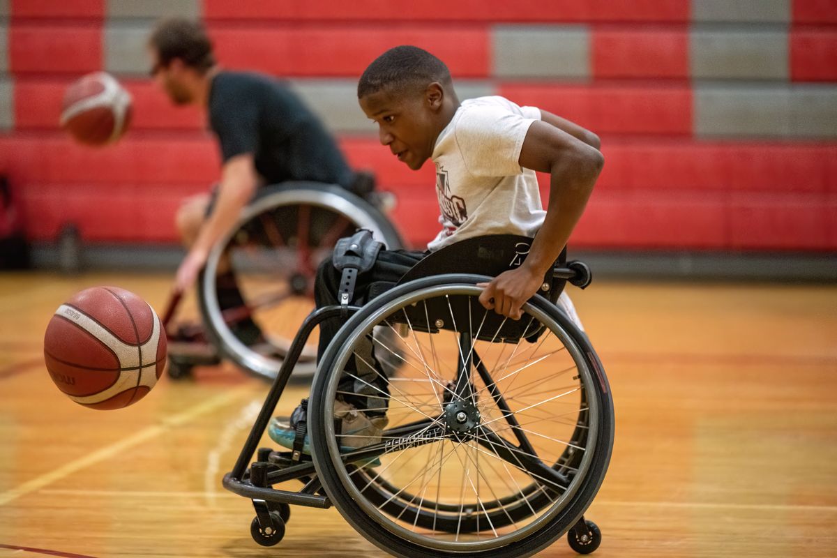 Aiden Youngblood, 15, dribbles the ball during wheelchair basketball practice Friday at the ParaSport Spokane’s new facility in the former Mountain View Middle School in the East Farms/Newman Lake area.  (COLIN MULVANY/THE SPOKESMAN-REVI)