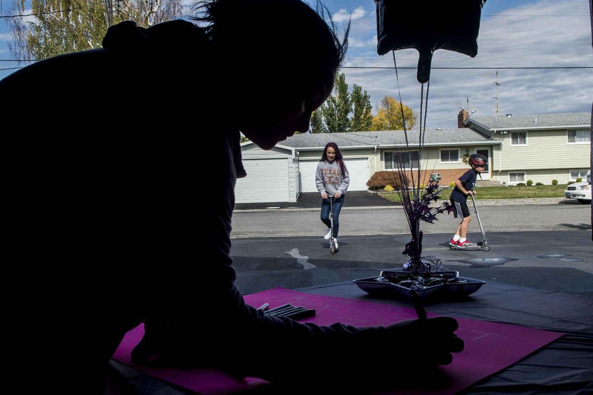 Avery McFarland, center, rides her scooter while a guest signs the poster during McFarland’s 13th birthday party in Spokane Valley on Saturday, Oct. 1. McFarland and her mother, Stephanie Skupien, had  been apart for nine years due to a dispute with McFarland’s father. This is the first birthday they’ve spent together since the girl was 3 years old. (Kathy Plonka / The Spokesman-Review)