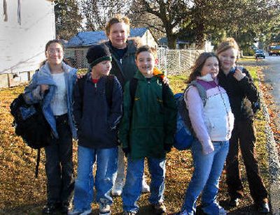 
Patty Arthur spends mornings with Kiauna Wilson, Alex Hanson, Grant Bischoff, Makela Saunders and Aubrey Cox playing school games at the bus stop. The self-proclaimed Bus Stop Bunch temporarily attend Browne Elementary School while Ridgeview is being reuilt. 
 (Kandis Carper / The Spokesman-Review)