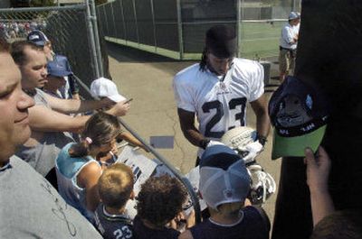 
Former WSU and now Seattle Seahawks player Marcus Trufant signs autographs for fans Friday at training camp in Cheney. 
 (Christopher Anderson/ / The Spokesman-Review)