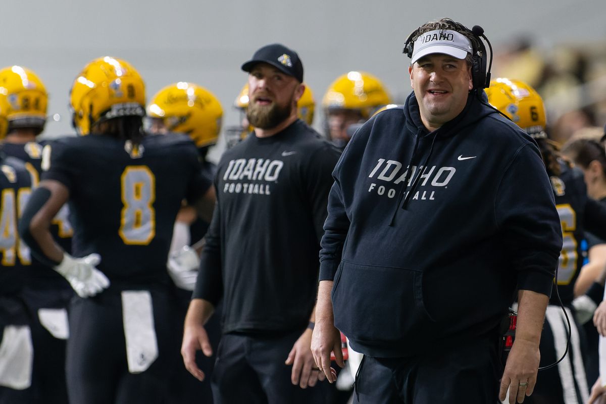 Idaho head coach Jason Eck, right, gives instructions from the sideline during the first half of a playoff game against Albany on Dec. 9 at the Kibbie Dome in Moscow, Idaho.  (Geoff Crimmins/The Spokesman-Review)