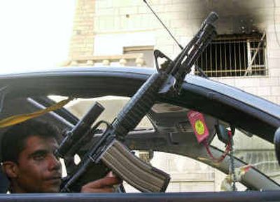 
Palestinian Zakaria Zbeida, the leader of the al-Aqsa Martyrs Brigades militant group in the West Bank town of Jenin, holding his automatic rifle, drives past the town's Governorate building early Saturday after members of the group set it on fire overnight. About a dozen armed militants from the group  wanted by Israel broke into the building, fired automatic weapons into the offices and set the building on fire to demand financial help from the Palestinian Authority.Palestinian Zakaria Zbeida, the leader of the al-Aqsa Martyrs Brigades militant group in the West Bank town of Jenin, holding his automatic rifle, drives past the town's Governorate building early Saturday after members of the group set it on fire overnight. About a dozen armed militants from the group  wanted by Israel broke into the building, fired automatic weapons into the offices and set the building on fire to demand financial help from the Palestinian Authority.
 (Associated PressAssociated Press / The Spokesman-Review)