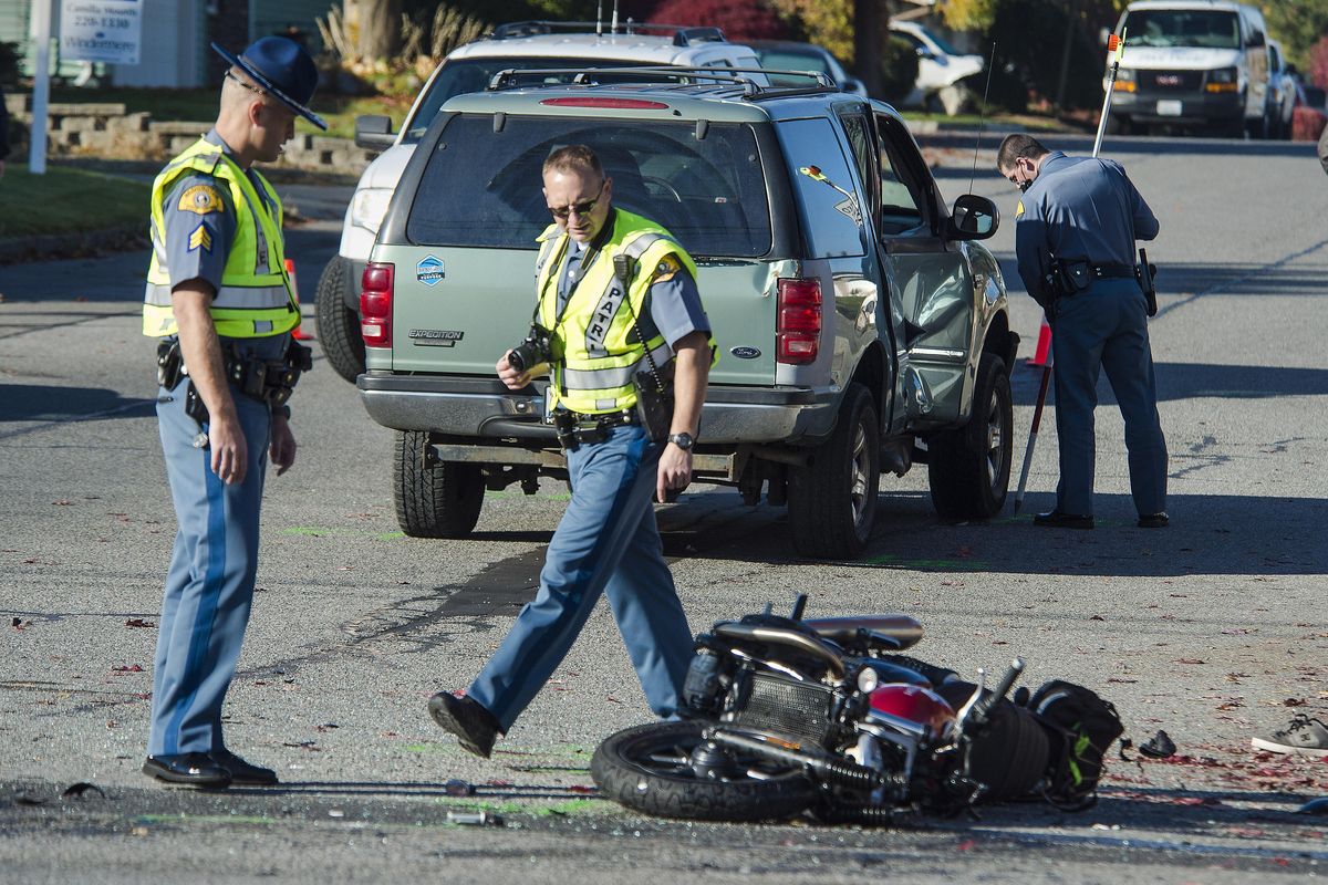 Washington State Patrol Sgt. Matt Fehler, left, along with WSP Troopers Eric Wickman, center, and Michael Valentine, investigate a fatal accident, Thursday, Oct. 26, 2017, at the corner of Pines Road and Grace Street in Spokane Valley, Wash. (Dan Pelle / The Spokesman-Review)