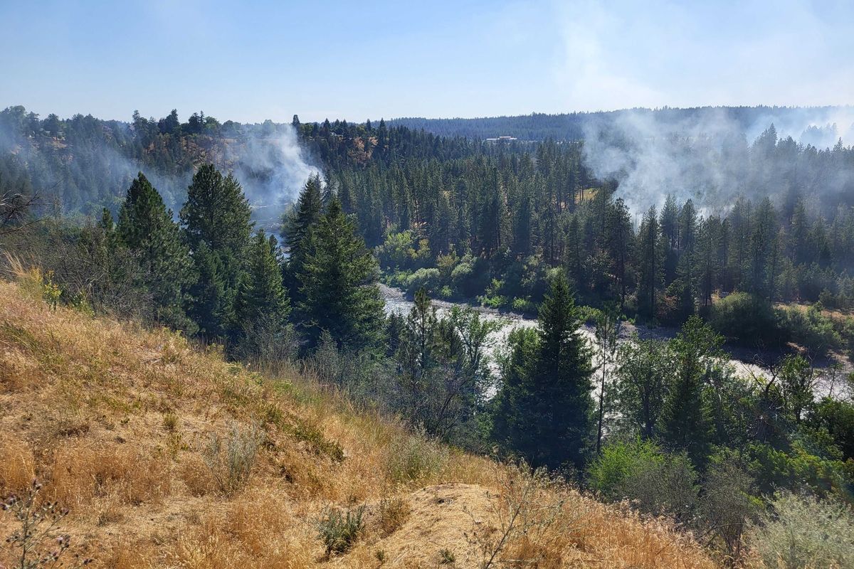 Smoke rises above the Spokane river Tuesday afternoon. Smoke seen Tuesday afternoon from the Elliott fire along the Spokane River near the T.J. Meenach Bridge.  (Corbin Vanderby / The Spokesman-Review)