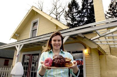 
April Gross shows off a plate of her delicious doughnuts in front of The Donut House on Wednesday. April and her husband, Matt, own and operate the Hayden business. 
 (Kathy Plonka / The Spokesman-Review)