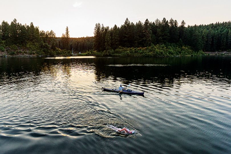 Randy Hixon, top, provides kayak support as Elaine Howley, a Boston-based marathon swimmer, begins her solo swim, of more than 30 miles, of the full length of Lake Pend Oreille�s Buttonhook Bay Wednesday near Farragut State Park. Howley is scheduled to finish the open water swim at the city beach in Sandpoint on Thursday afternoon. (Shawn Gust/press)