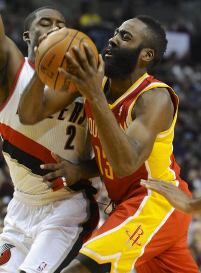 Rocketss’ James Harden, right, goes to the basket as Trail Blazers' Wesley Matthews defends in Thursday night’s game. (Associated Press)
