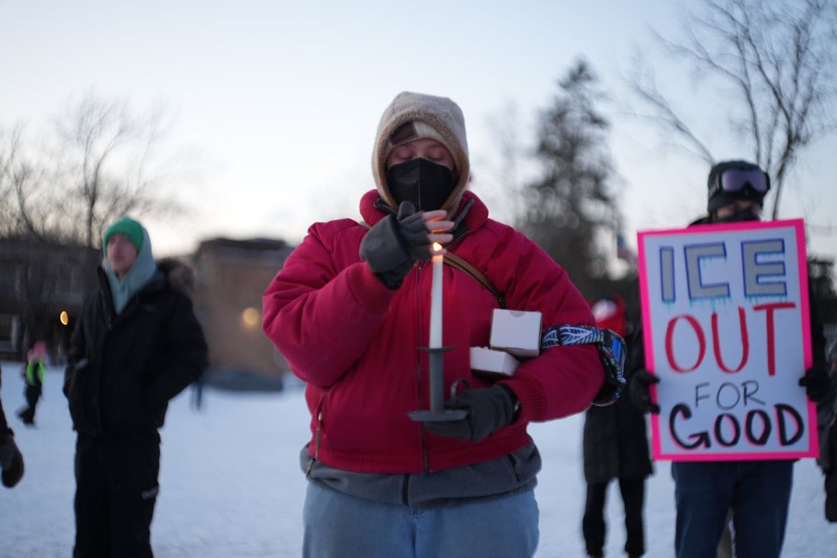 People gather for an early evening vigil in Whittier Park and light candles for Alex Pretti, who was fatally shot by federal agents in south Minneapolis on Saturday.  (Minnesota Star Tribune)