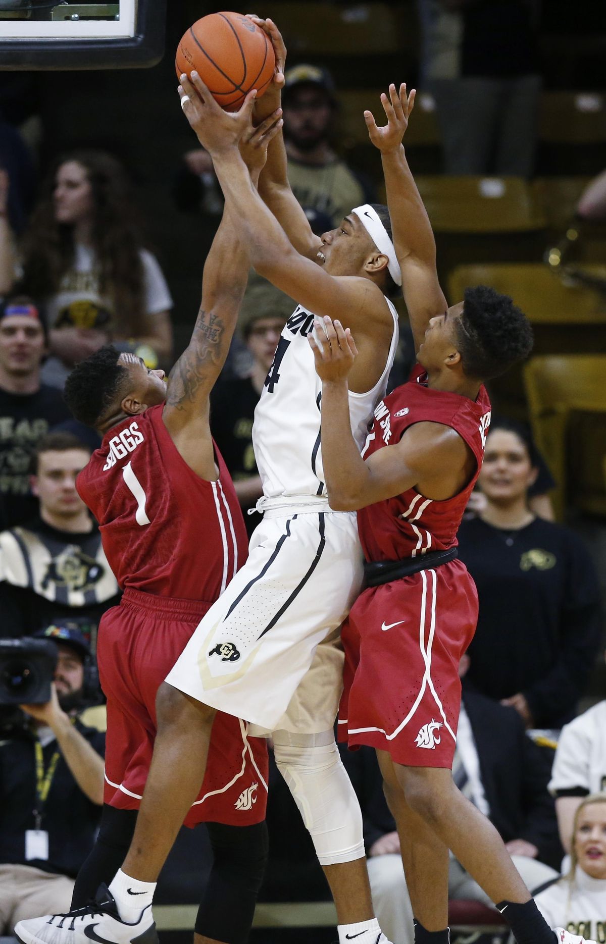 Colorado guard George King, center, battles for control of an offensive rebound as Washington State guards Renard Suggs, left, and Ny Redding defend in the first half of an NCAA college basketball game Thursday, Feb. 11, 2016, in Boulder, Colo. (David Zalubowski / Associated Press)