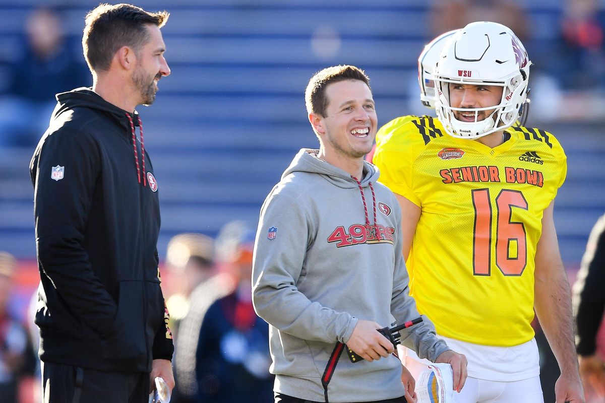WSU quarterback Gardner Minshew (16) laughs with 49ers head coach Kyle Shanahan, left, and wide receivers passing game coordinator Mike LaFleur during a Senior Bowl practice session on Thursday, January 24, 2019, at Ladd-Peebles Stadium in Mobile, Ala. (Tyler Tjomsland / The Spokesman-Review)