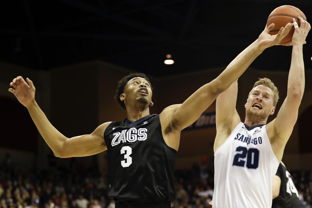 Gonzaga forward Johnathan Williams (3) and San Diego forward Cameron Neubauer (20) reach for a rebound during the first half of an NCAA college basketball game Thursday, Feb. 23, 2017, in San Diego. (Gregory Bull / Associated Press)