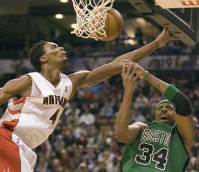 Toronto's Chris Bosh, left, soars in to defend as Boston's Paul Pierce tries to get a shot off during the first half.Associated Press
 (Associated Press / The Spokesman-Review)