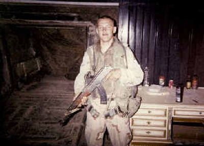 
Army Spc. Robert Benson sent home this photograph of himself taken in Iraq with a confiscated AK-47 rifle. 
 (Photo courtesy of Benson family / The Spokesman-Review)