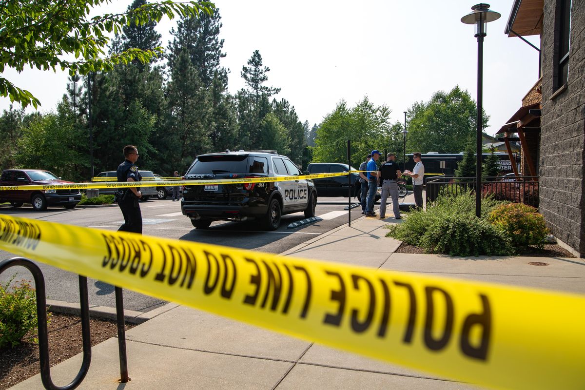 Coeur d’Alene police and local law enforcement are seen outside of the Global Credit Union Coeur d’Alene branch, where a suspect died on the afternoon of Saturday, Aug. 11, 2018 from a gunshot following an attempted robbery. (Libby Kamrowski / The Spokesman-Review)