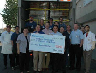 
Albertson's stores donated $5,000 with an oversized check in addition to a large semitrailer full of food stuffs weighing in with 36,982 pounds of food
 (The Spokane Association of REALTORS® / The Spokesman-Review)