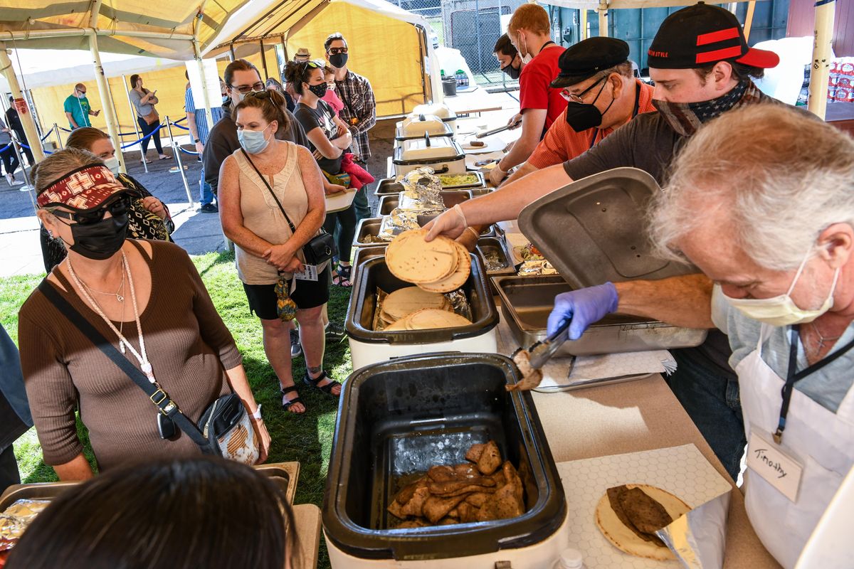 Holy Trinity Greek Orthodox Church Greek Food Fest volunteers, serve up gyros and loukaniko pitas for take-out orders, Thursday, Sept. 23, 2021, in Spokane.  (DAN PELLE/THE SPOKESMAN-REVIEW)