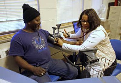 
David Thomas gets his blood pressure checked by parish nurse and program coordinator Brenda Buchanan at a clinic that works with the New Life Presbyterian Church Food Pantry  in Milwaukee. Associated Press
 (Associated Press / The Spokesman-Review)