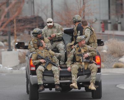 SWAT team members are trucked from to the Renown Medical Center where a lone gunman shot and injured four people before killing himself Tuesday in Reno, Nev. (Associated Press)