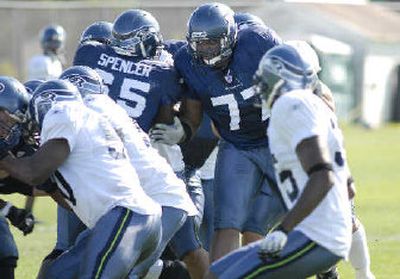 
Seahawks starting left guard Floyd Womack, center, mixes it up during Wednesday's training camp drills. 
 (Amy Sinisterra Associated Press / The Spokesman-Review)