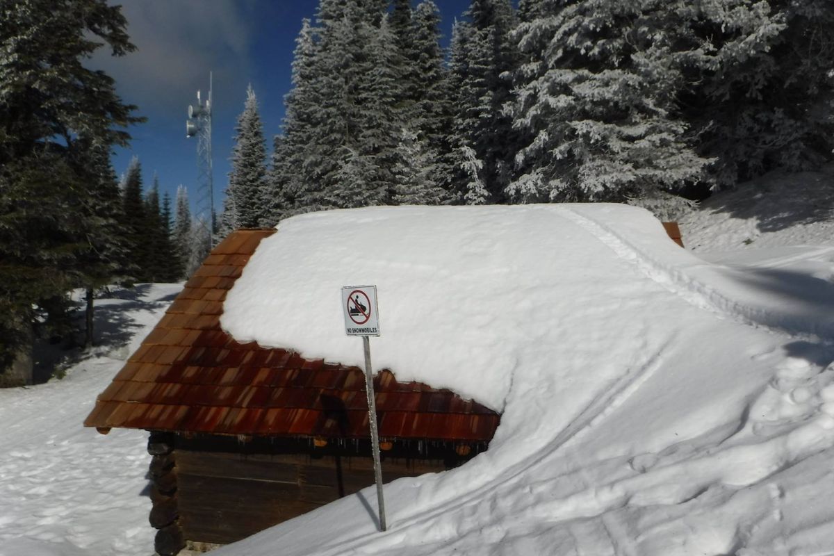  A snowgoer on tracked machine ignores a sign and common sense by riding a snowdrift over a refurbished structure at Mount Spokane State Park. (Holly Weiler)