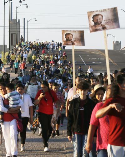 Faithful walk in a pilgrimage from St. James the Greater Catholic Church to attend the beatification ceremony for the Rev. Stanley Rother at the Cox Convention Center in downtown Oklahoma City, Saturday, Sept. 23, 2017. (Doug Hoke / Associated Press)