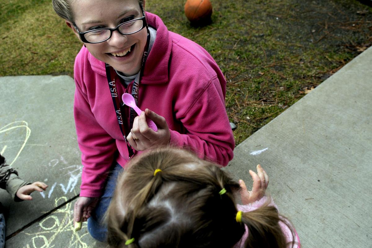Krista McNamee works with a child at Children’s Village recently.  She and her siblings once lived there. (Kathy Plonka)