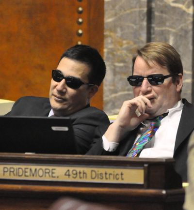 Sens. Craig Pridemore and Steve Hobbs don sunglasses on Tuesday, April 12, on the Senate floor during debate on a bill involving embalmers. (Jim Camden/The Spokesman-Review)