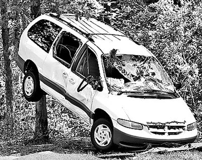 A van is propped against a tree at Albert Pike campground near Caddo Gap, Ark., Saturday after a flash flood early Friday.  (Associated Press)