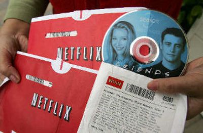 
A Netflix customer Mei Michelson holds up a DVD from the television series 