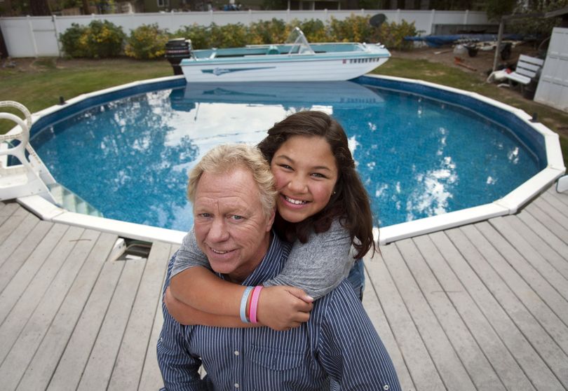 Tim Lorentz has produced his latest creation, the LaFloata, a full-size speedboat that is moored in his backyard swimming pool at his South Hill home in Spokane, Wash. His daughter Allie is a fan of the new attraction. Lorentz also merged a car and boat that he often drives around Spokane, called LaBoata. (Dan Pelle)