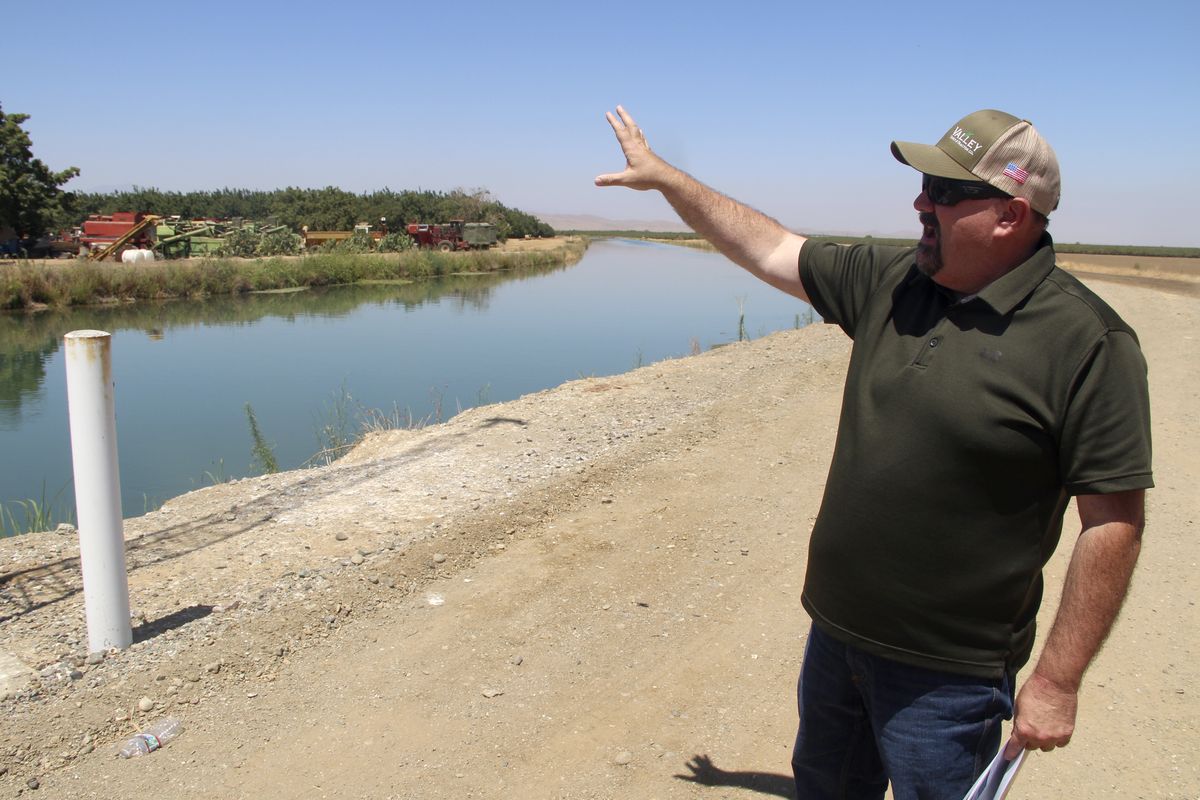 Kevin Spesert, public affairs and real estate manager for the Sites Project Authority, points out the main canal of the Glenn Colusa Irrigation District on July 23 near Sites, Calif.  (Adam Beam)