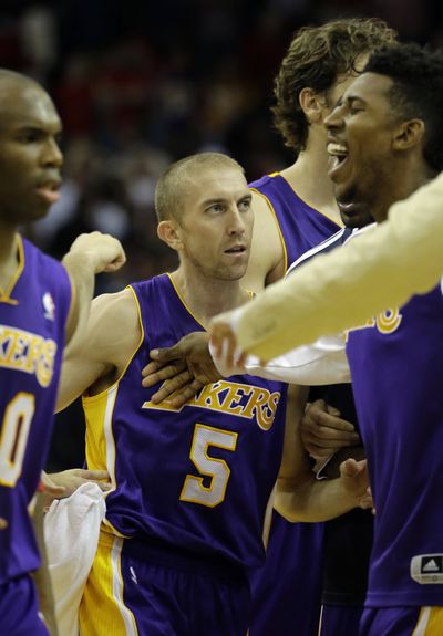 Steve Blake, center, hit the Lakers’ game-winner over Houston. (Associated Press)