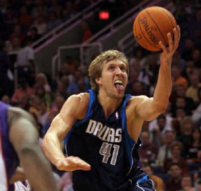 
Dirk Nowitzki led the Mavericks with 35 points in a 119-112 win over Phoenix.
 (Associated Press / The Spokesman-Review)