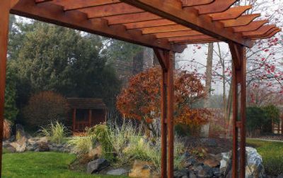 
Neil and Heather O'Keefe turned their back yard into an Inland Northwest hideaway.  The trellis will eventually be covered with floral and grape vines. 
 (Kathryn Stevens / The Spokesman-Review)