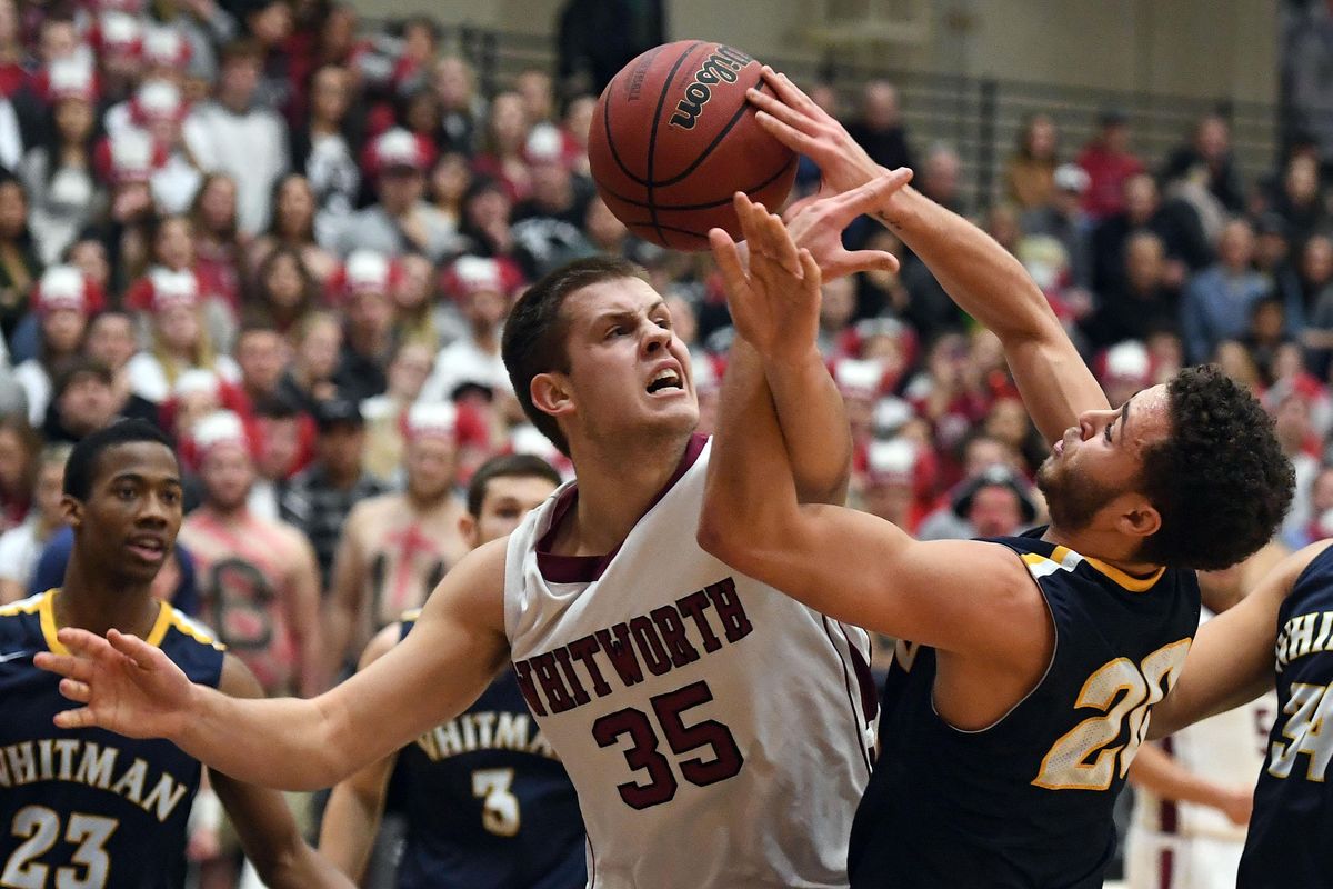 Whitworth Ben Bishop (35) tangles up with Whitman Jase Harrison (20) during a rebound in the first half of a college basketball game, Tues., Jan. 24, 2017, at at Whitworth University. (Colin Mulvany / The Spokesman-Review)